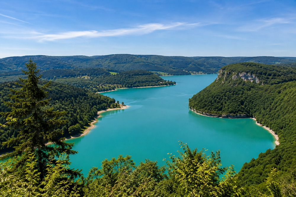 Paysage du lac de Vouglans avec ses eaux turquoise au cœur de la nature jurassienne
